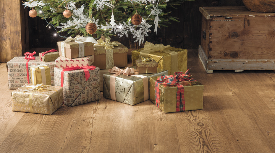 Gold and red presents under a Christmas tree on Reclaimed Heart Pine LLP305 flooring